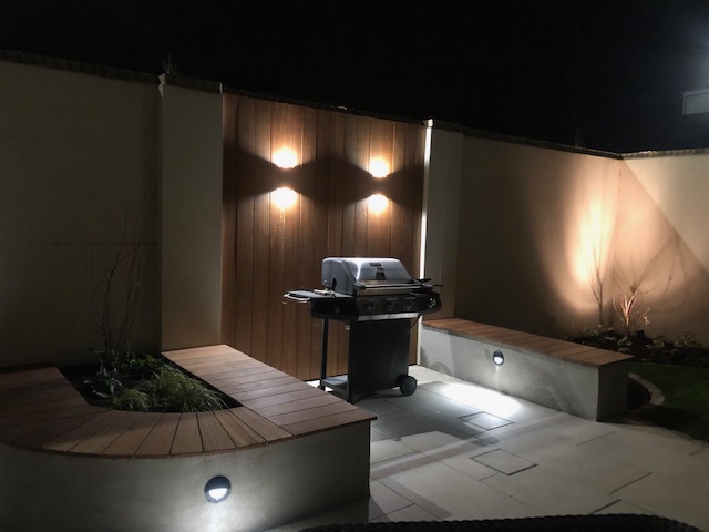 BBQ area with Built in Seating and decorative lighting